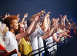 © Julie Francoeur/peopleimages.com - Crowd in fence row, fans at music festival or concert watching rock event on stage. Excited people in audience at band performance at arena, stadium or party with applause and energy at night show.