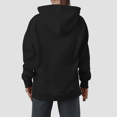Wall Mural - Mockup of a quality long black hoodie on a girl, back view, fashionable apparel for design, brand, product photography for commerce.
