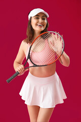 Wall Mural - Young woman with tennis racket on pink background