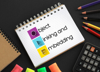 Poster - OLE Object Linking and Embedding - technology that allows embedding and linking to documents and other objects, acronym text on notepad