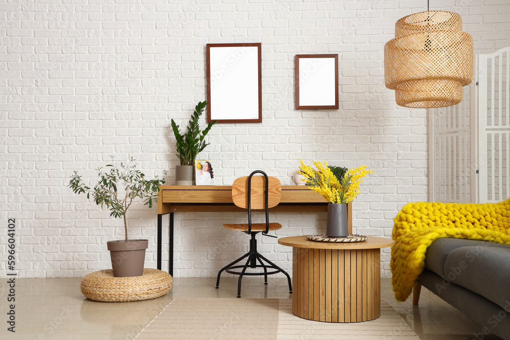 Interior of stylish living room with workplace and coffee table