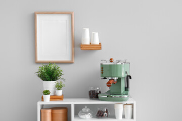 Wall Mural - Modern coffee machine, jar with beans and houseplants on table near white wall