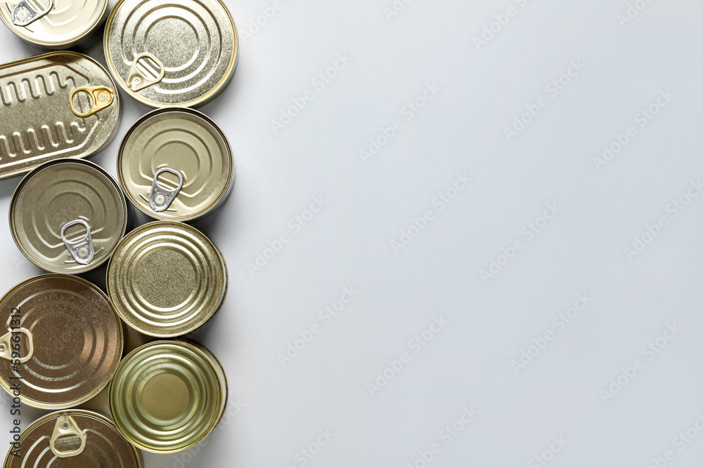 Assortment of tin cans with fish on white background