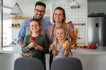 Wall Mural - Happy family preparing healthy food together in kitchen