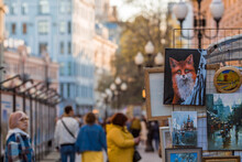 Old Arbat And Paintings By Artists. People Are Walking In The City Center. Russia, Moscow 2023