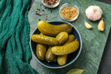 Fototapeta Kawa jest smaczna - Bowl with tasty fermented cucumbers on dark grunge background