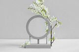 Fototapeta Kawa jest smaczna - Decorative podium and blooming branch on grey background