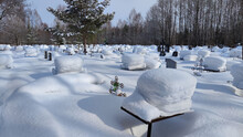Ukrainian Traditional Cemetery In Snowy Winter. Many Of Unmarked And Faceless Gravestones And Crosses With Forest In Background. Graves In Russia After Ward