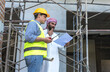 © Jack Tamrong - Engineer Construction standing with arab investor man looking at construction project