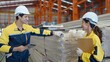 © M Stocker - Two industrial worker in uniform holding tablet checking quality of metal sheet roof for industry construction at manufacturing factory