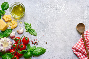 Canvas Print - Traditional ingredients of italian cuisine : pasta, tomatoes,garlic,olive oil and parmesan cheese . Top view with copy space.