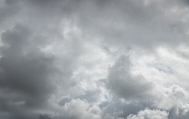 Dramatic background caused by dark clouds in the sky. Forecast of rain, thunderstorm, bad weather. The beauty of nature. Abstract background image.