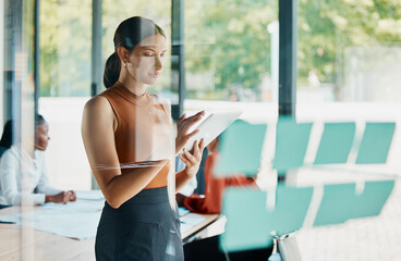 Poster - Things get done in this boardroom. Cropped shot of an attractive young businesswoman using her tablet while standing in the boardroom.