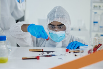 Aufkleber - What a disaster. Shot of a young scientist cleaning up a mess at a lab.