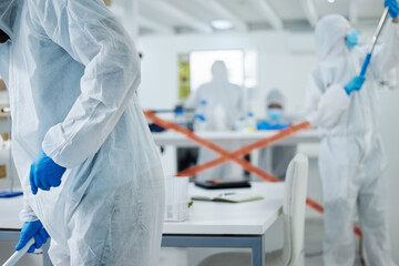 Sticker - Its off limits. Shot of a group of scientists cleaning up a mess at a lab.