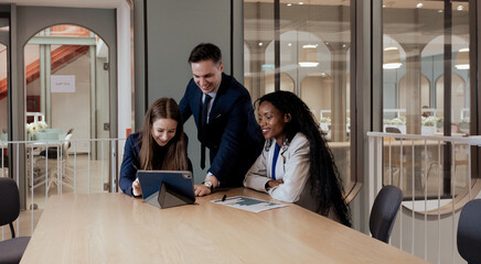 Diverse ethnic team of professional businesspeople meeting discussion in office. Businessman and diversity colleagues talking planning and brainstorming corporate startup project strategy together.