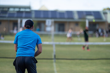 Wall Mural - Amateur playing tennis at a tournament and match on grass in Europe 