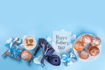 Wall Mural - Father's day holiday greeting card. Father's Day morning breakfast with a cute surprise background, with gift boxes, cupcakes, coffee mug, heart decor, tools and ties, Happy Father's Day letter