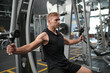 © FotoArtist - Man doing weight lifting exercises inside the gym