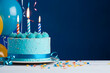 © 92ashrafsoomro - A blue birthday cake with candles on it, copy space generative ai