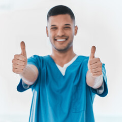 Poster - Here to aid and assist. Portrait of a young doctor showing thumbs up in a hospital.