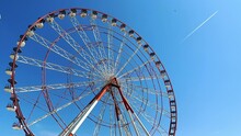 Ferris Wheel With Blue Sky And Cloudy Background