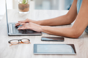 Poster - Closeup of mixed race business womans hands and fingers typing on laptop keyboard at a table in an office. One female only sending emails while busy with research and planning online for her startup