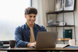 © Prostock-studio - Happy Arabic Man Using Laptop Sitting At Table In Office