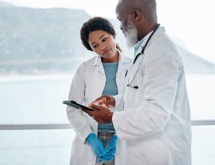 Poster - Dedicated to saving lives at all costs. Shot of two doctors using a digital tablet together in a medical office.
