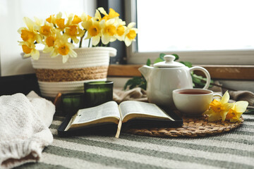 Wall Mural - Open Bible in a cozy home interior. Good morning