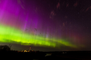 aurora borealis, the northern lights at kuldiga, latvia.