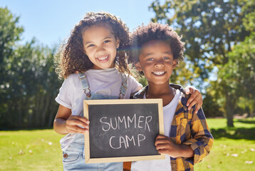 Wall Mural - Two besties in a summer camp pod. Shot of a two friends holding a sign in a outside in a park.