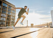 © Nicholas Felix/peopleimages.com - I dont hit the gym regularly but I workout everyday. Shot of a sporty young man out on a rooftop for a workout.