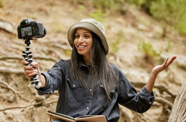 Wall Mural - Look where I am. Cropped shot of an attractive young woman taking selfies while hiking in the wilderness.