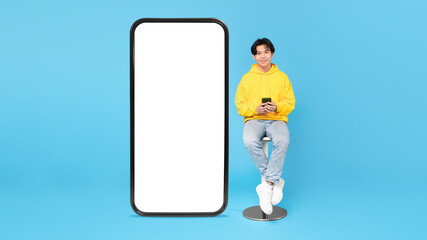 Sticker - Asian Teen Guy Sitting Near Big Phone Screen, Blue Background