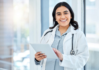 Canvas Print - Doing her rounds with her digital assistant. Portrait of a young doctor using a digital tablet in a hospital.