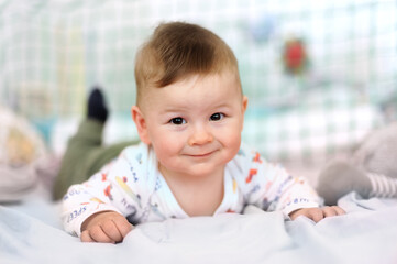 Wall Mural - Portrait of cute baby boy looking at camera. Joy and happiness concept. Love and family emotion