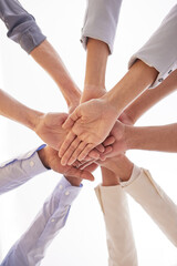 Poster - It helps to have the support of your team. Low angle shot of a group of unrecognisable businesspeople joining their hands together in a huddle in an office.