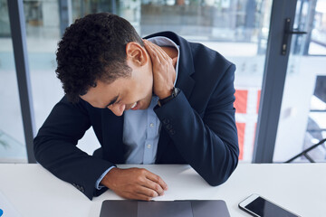 Poster - Stressed out and feeling it. Shot of a young businessman experiencing neck pain while working in an office.