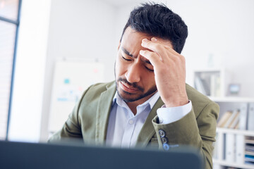 Poster - Hes really suffering. Cropped shot of a handsome young businessman looking stressed while working in his office.
