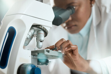 Poster - I might be able to see the problem. Shot of an unrecognisable scientist using a microscope to analyse a sample in the laboratory.