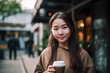 Pretty young Chinese woman holding a cup of coffee or tea outside in a market. generative AI
