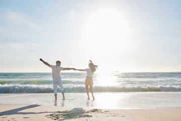 Sticker - Fun in the sun. Full length shot of an affectionate young couple having fun on the beach.