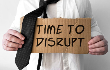 Poster - a disheveled business man holds up a cardboard sign with the words time to disrupt