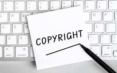 Poster - White paper with text Copyright lying on the keyboard