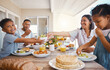 © Kirsten D/peopleimages.com - Hes excited to eat. Shot of a young family having lunch together at home.