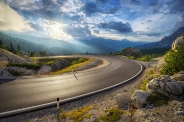 Wall Mural - mountain road at colorful sunset in summer. dolomites, italy. beautiful curved roadway, rocks, stone