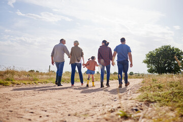 Poster - Living a simple, rural life. Shot of a multi-generational family walking together on a farm.