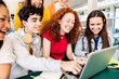 © Xavier Lorenzo - Young group of student people studying together at college campus. High school millennial teenage classmate working on laptop sitting at cafeteria table. Education concept.