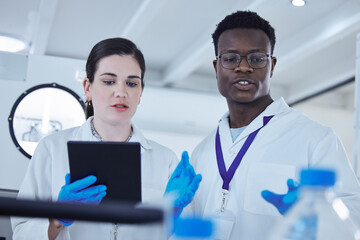 Poster - A day of innovation. Shot of two colleagues working together on a scientific project using a digital tablet.